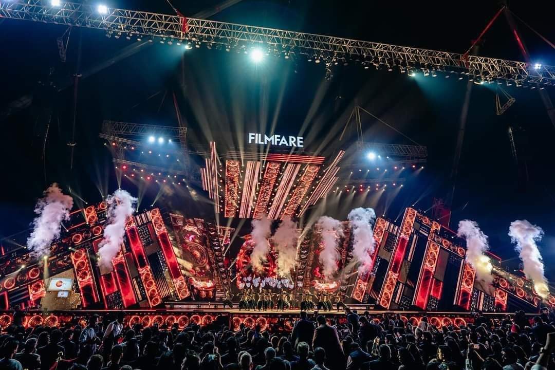 Live entertainment concert stage with spotlights and a cheering crowd